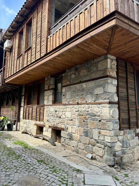 a stone building with a bench on the side of it at Sozopol Old Town - Apartment 4 in Sozopol