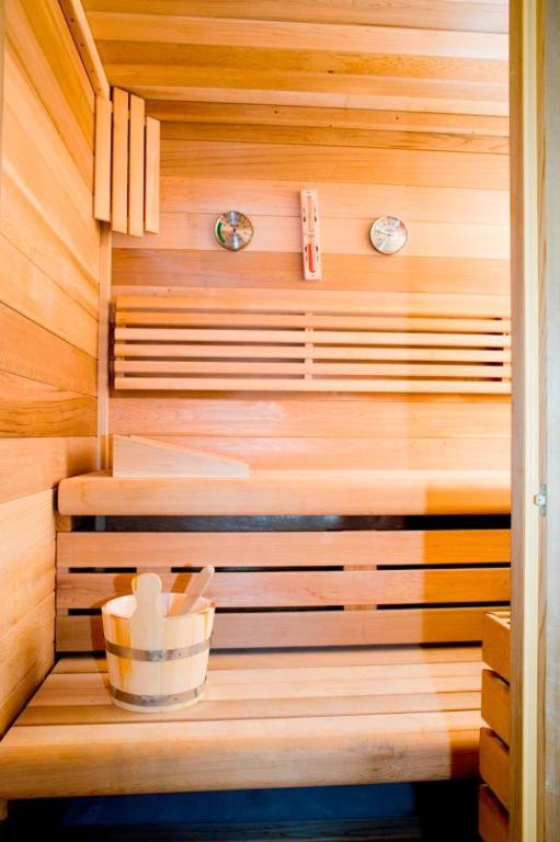 a sauna with a bucket on a wooden wall at Konstantinos Palace in Karpathos