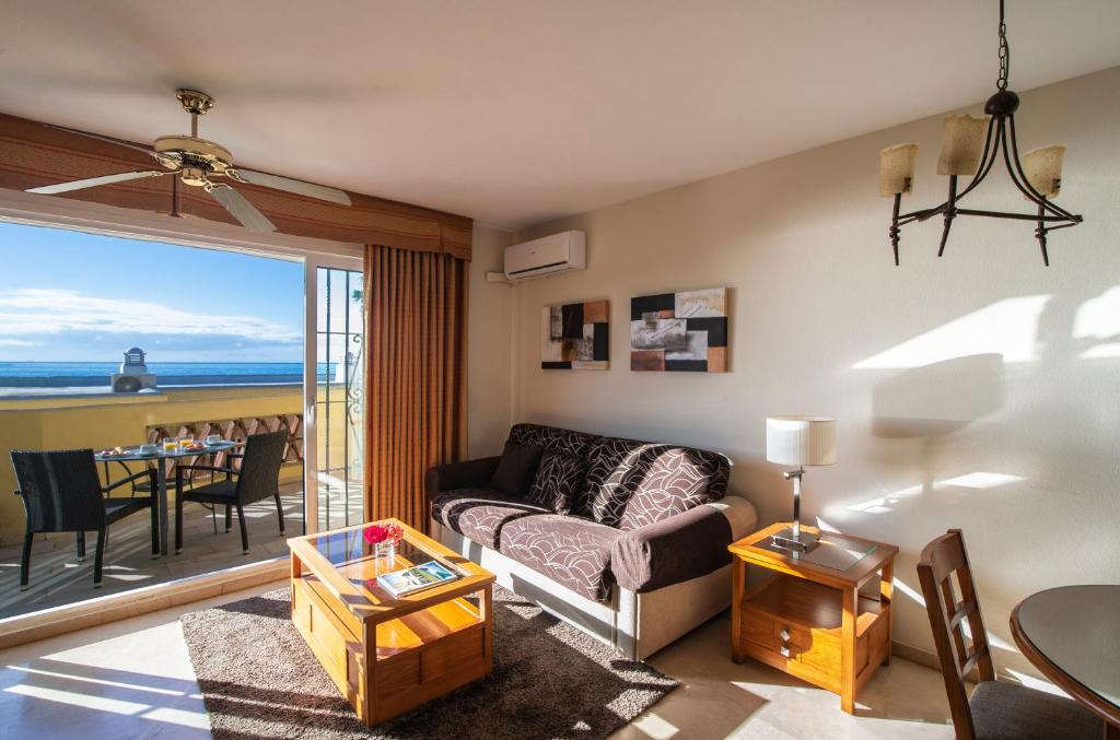 a living room with a couch and a table at Macdonald Doña Lola Resort in La Cala de Mijas