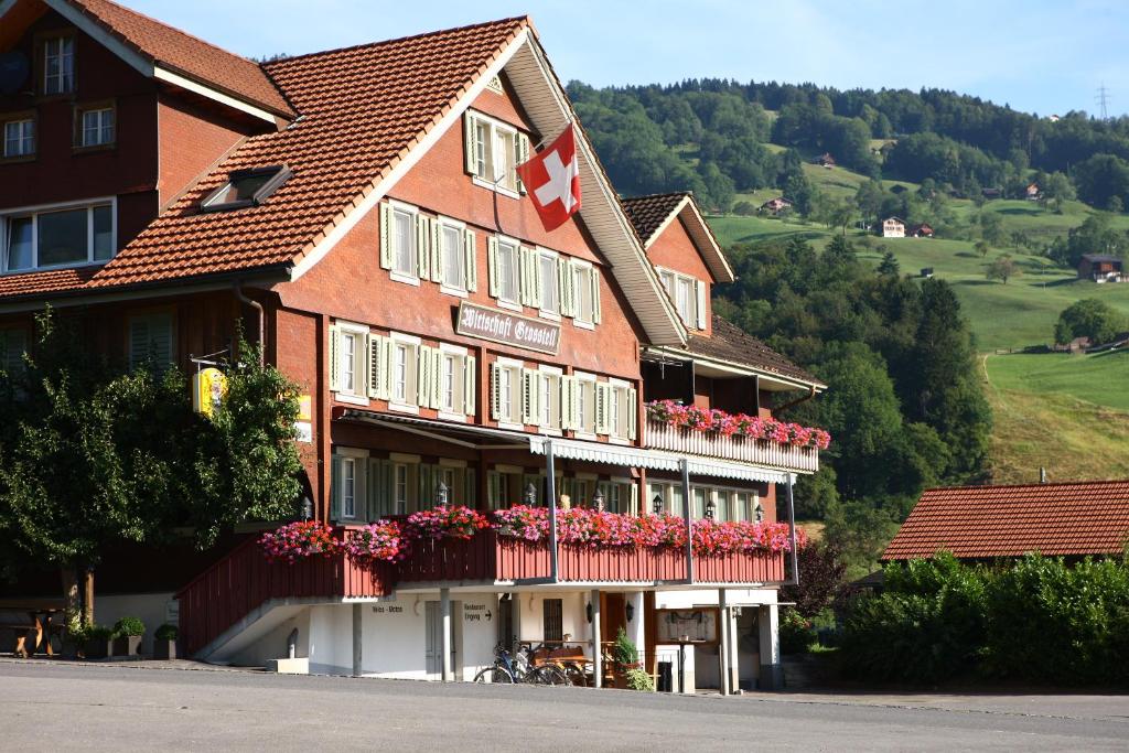 ein großes Gebäude mit Blumen davor in der Unterkunft Landgasthof Grossteil in Giswil