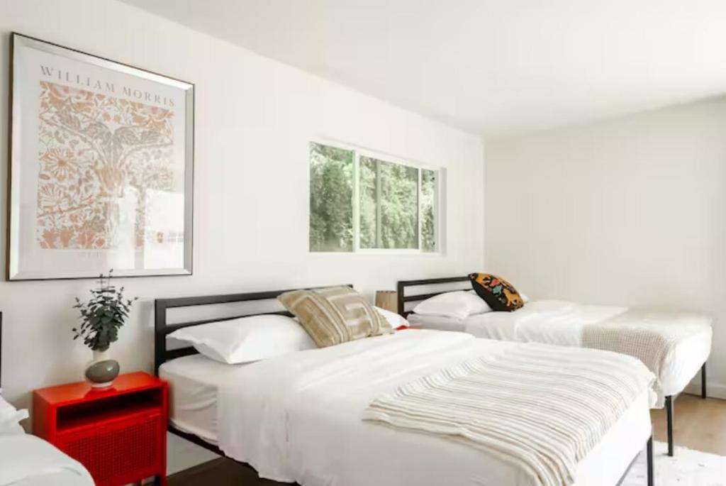 a bedroom with two beds and a red table at Hillside Retreat Heated Pool & Jacuzzi with Valley Views in Los Angeles
