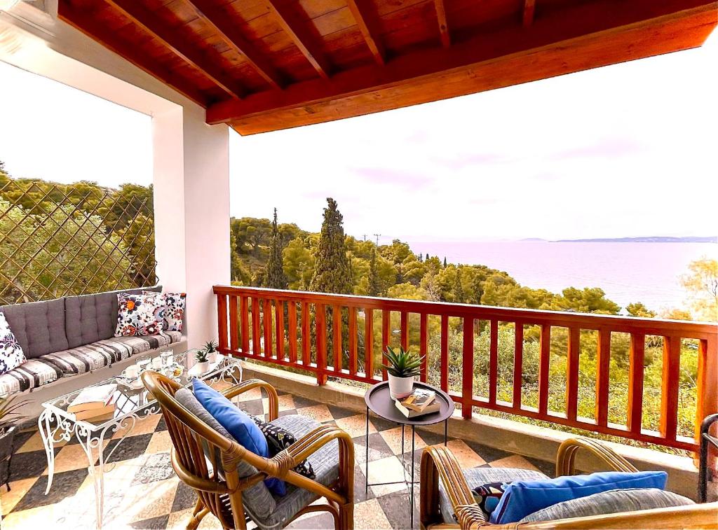 a porch with a view of the ocean at Casa Bianca Elegant House Near Beach in Spetses