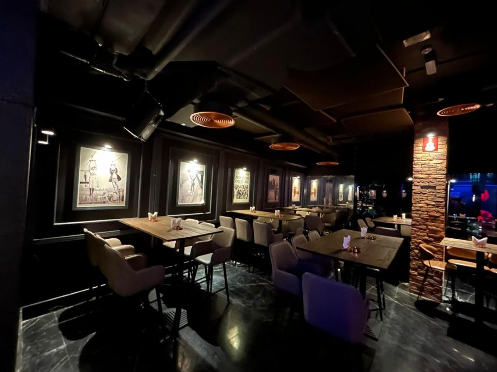 a restaurant with tables and chairs in a room at Signature 1 Hotel Tecom in Dubai