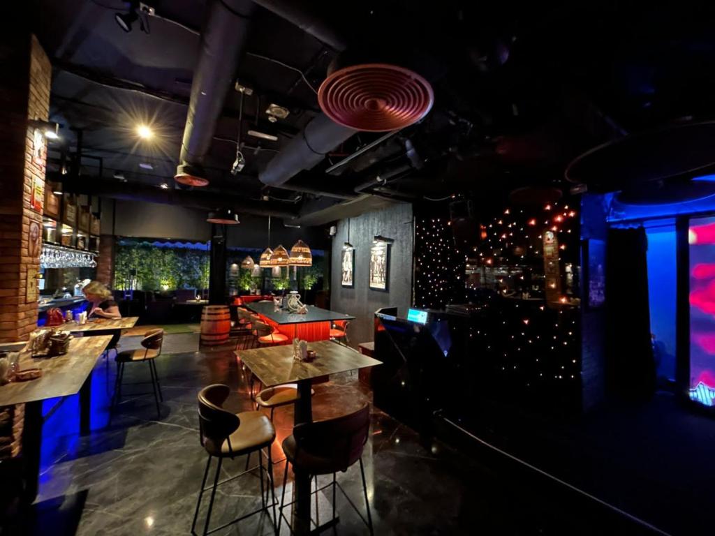 a restaurant with tables and chairs and a bar at Signature 1 Hotel Tecom in Dubai