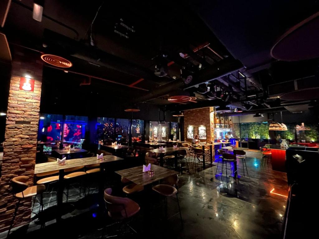 a bar with tables and chairs in a room at Signature 1 Hotel Tecom in Dubai