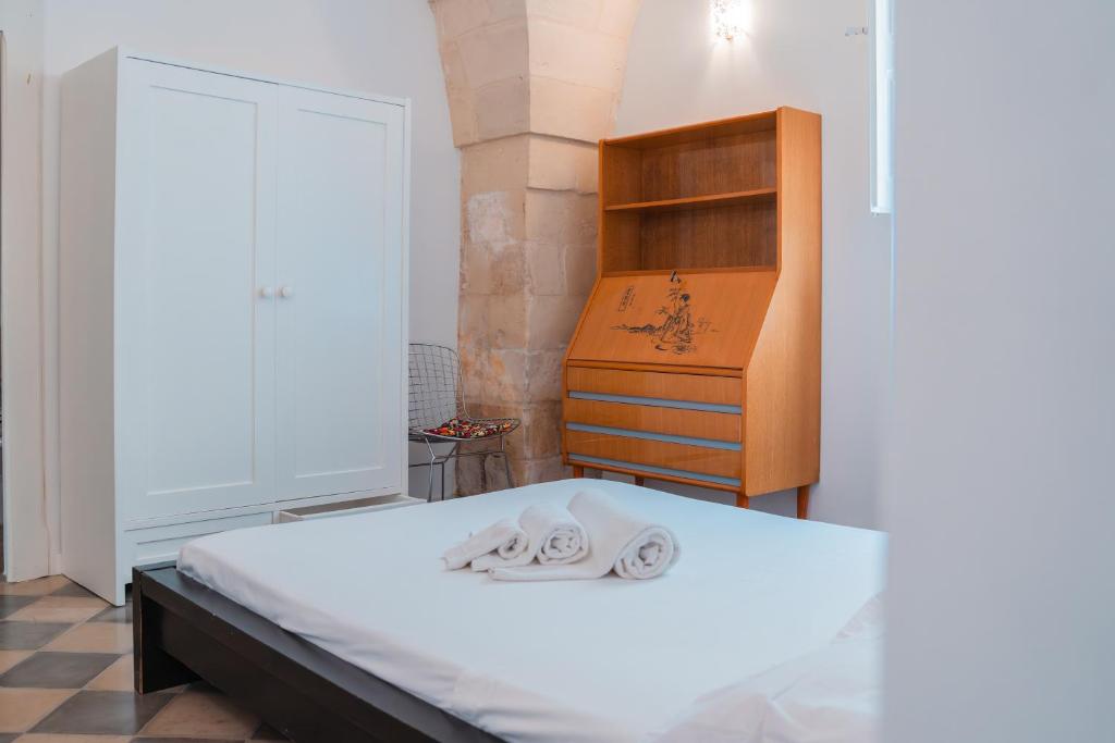 Ένα ή περισσότερα κρεβάτια σε δωμάτιο στο Don Rocco Historic Stay