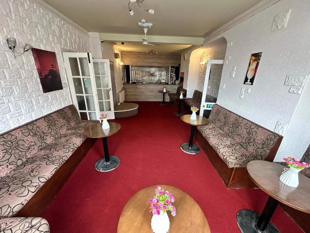 a room with couches and tables and a red carpet at Granby Hotel in Scarborough