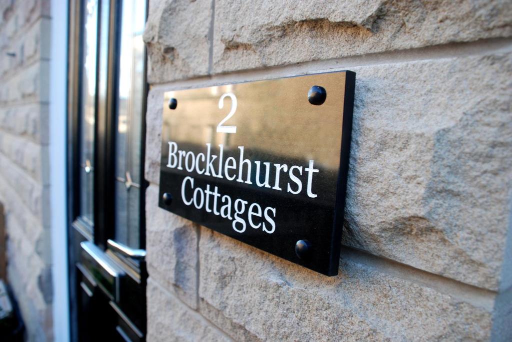 a sign on the side of a building at 2 Brocklehurst Cottages in Buxton