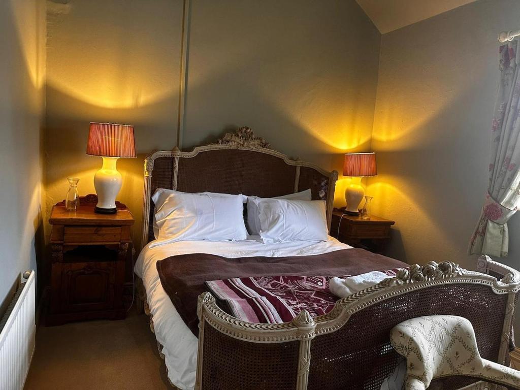 a bedroom with an old fashioned bed with two lamps at Stunning 2 bed Flat Near Belvoir Castle in Croxton Kerrial