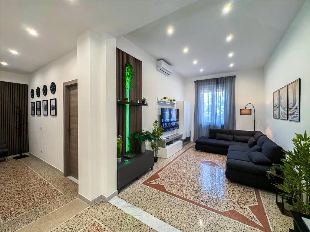 a living room with two couches and a tv at Rigel Apartments in Lido di Ostia