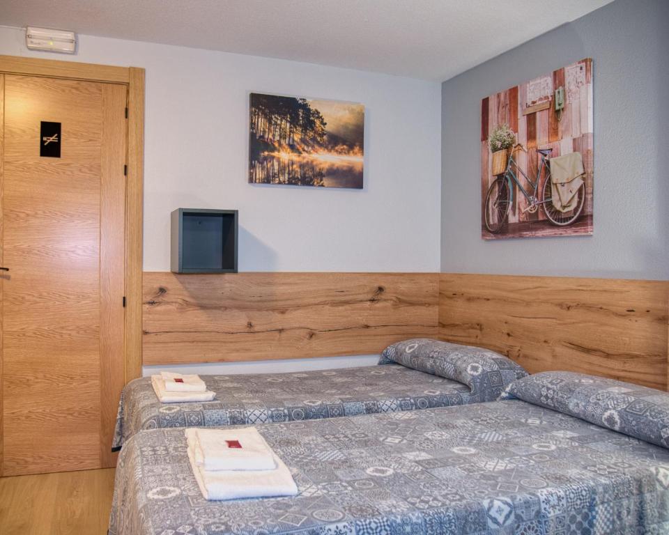 Postel nebo postele na pokoji v ubytování Pensión Pamplonabeds