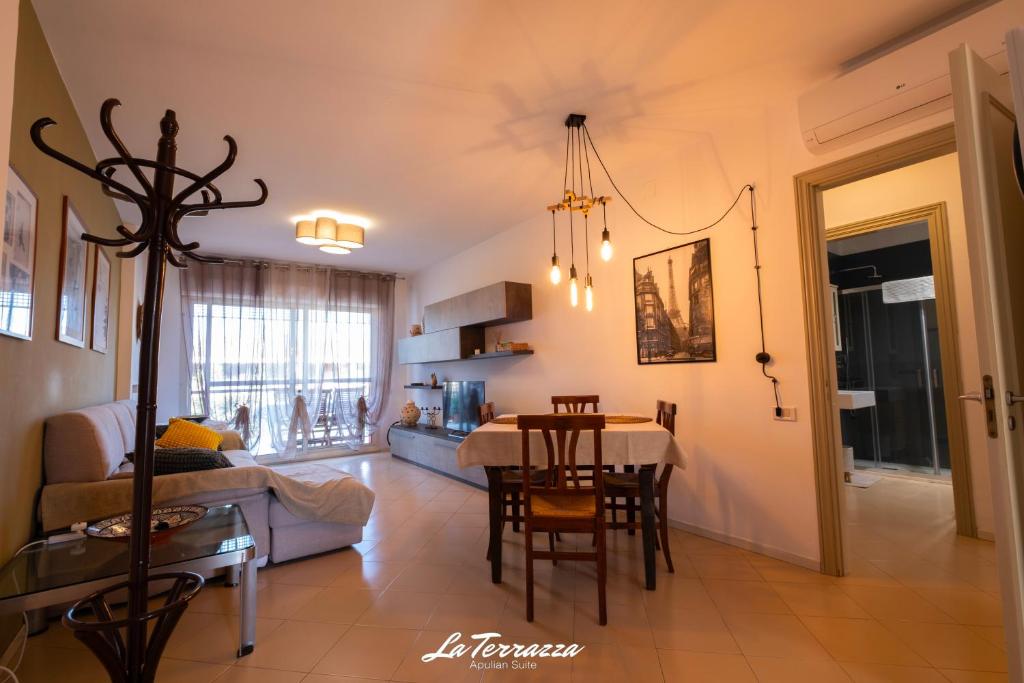 a living room with a table and a dining room at La Terrazza in Noicattaro