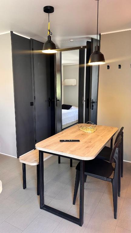 a dining room table with two lights and a bedroom at Camping Villa Park Zambujeira do Mar in Zambujeira do Mar