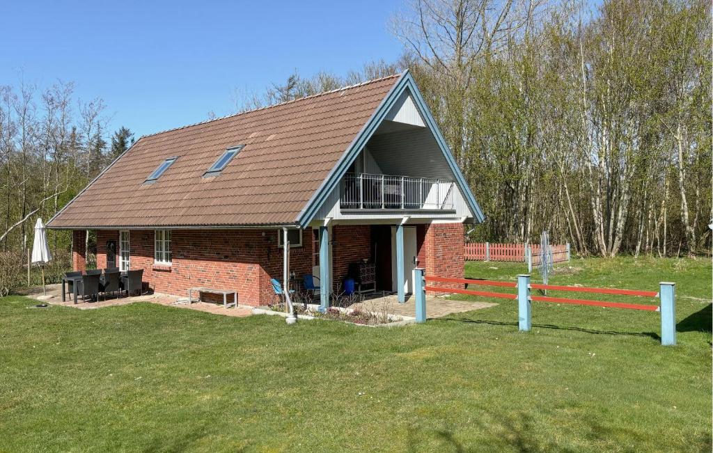 a red brick house with a porch and a balcony at Nice Home In Roslev With Wifi in Roslev