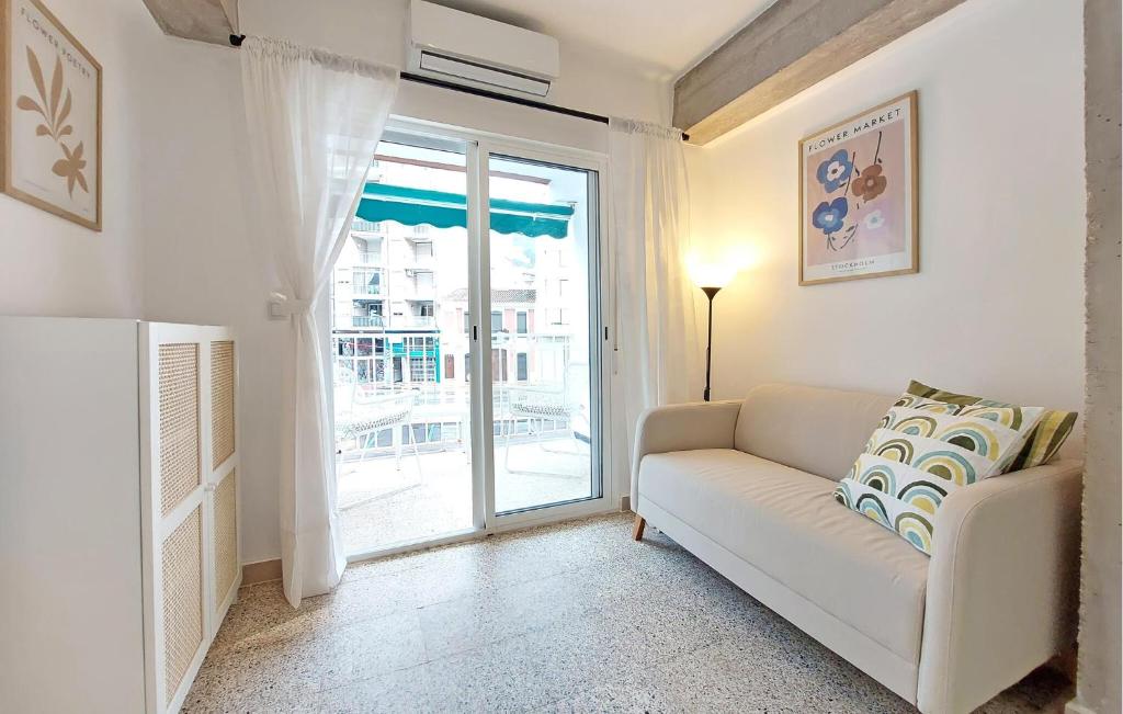 a living room with a couch and a sliding glass door at 2 Bedroom Amazing Apartment In Cullera in Cullera