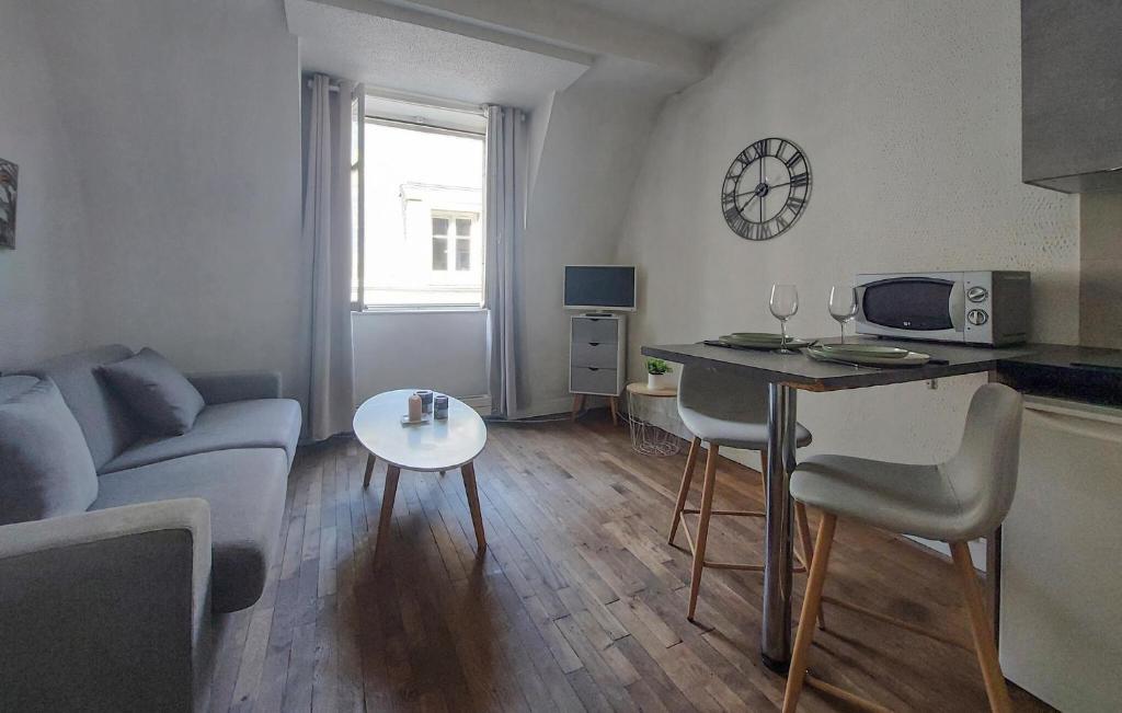 a living room with a couch and a table at Stunning Apartment In Saint-Malo in Saint Malo