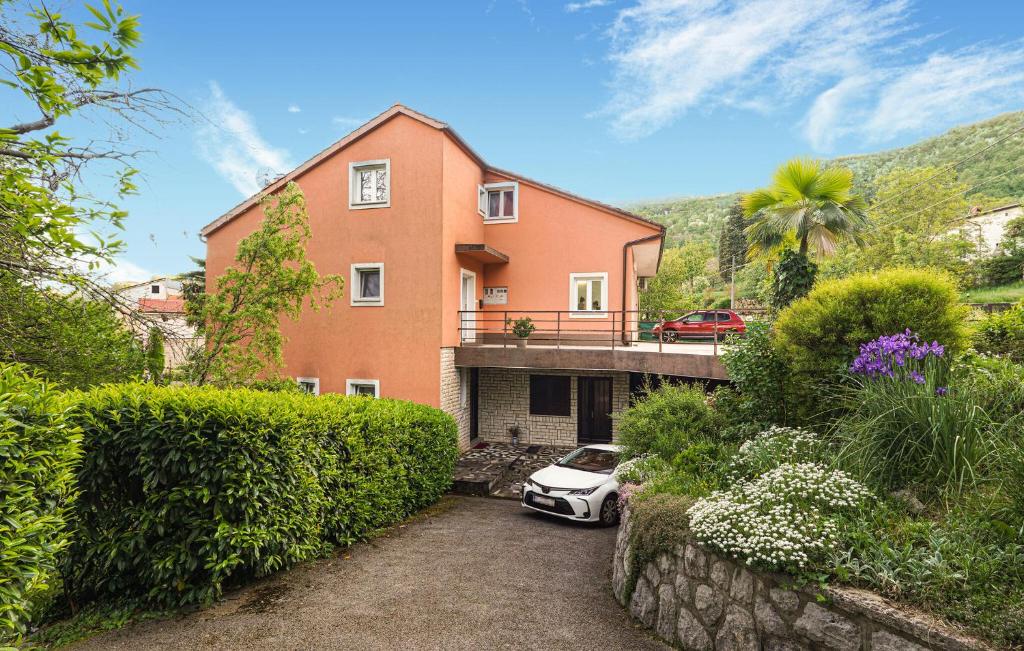 a white car parked in front of a house at 2 Bedroom Lovely Apartment In Lovran in Lovran