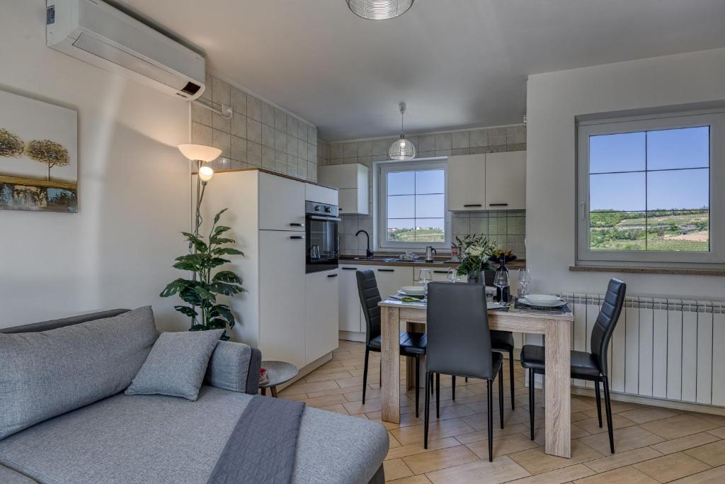 a living room and kitchen with a table and a couch at Neda Apartment In Krasno Among Vineyard - Happy Rentals in Šmartno