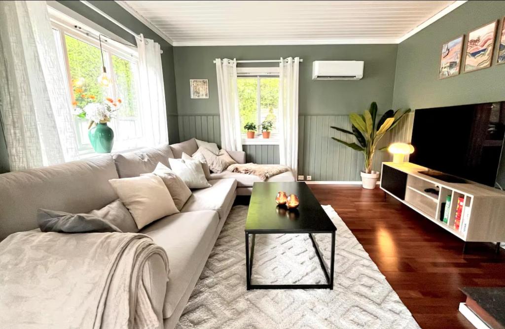 a living room with a couch and a coffee table at Anchor Point Farsund in Farsund