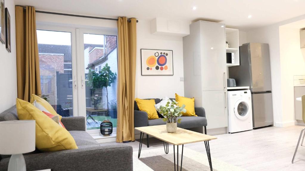 a living room with a couch and a table at Lovely 2 Bed Apartment w Garden near Northampton in Earls Barton