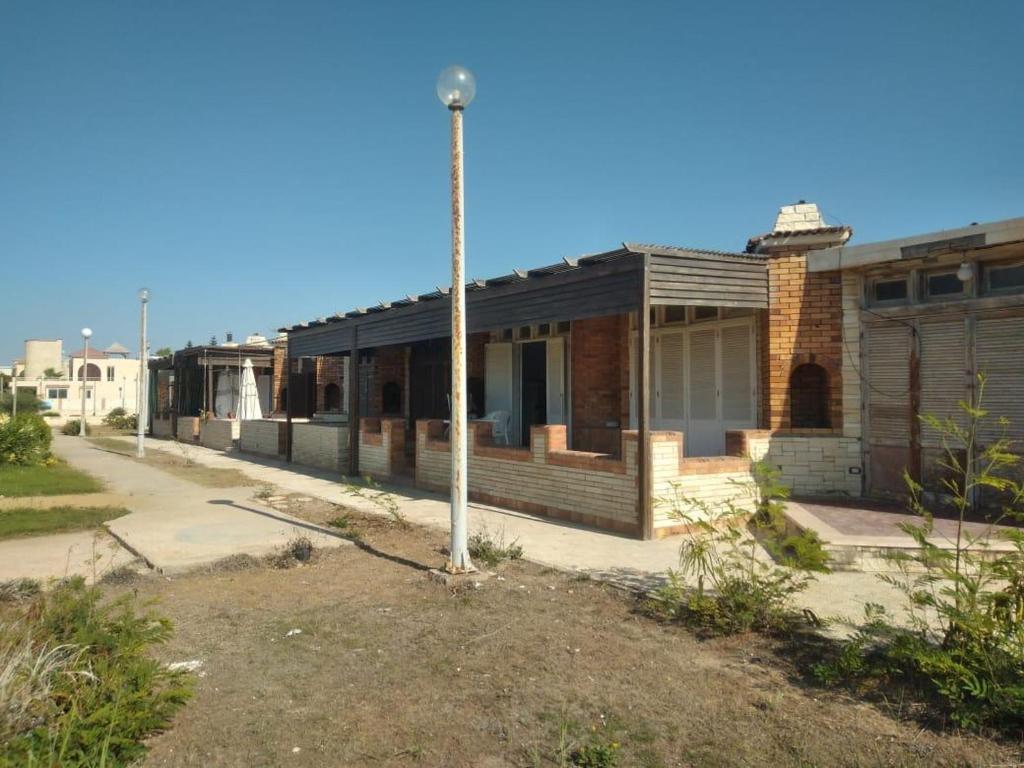 an old building with a pole in front of it at Doctor's village in Alexandria