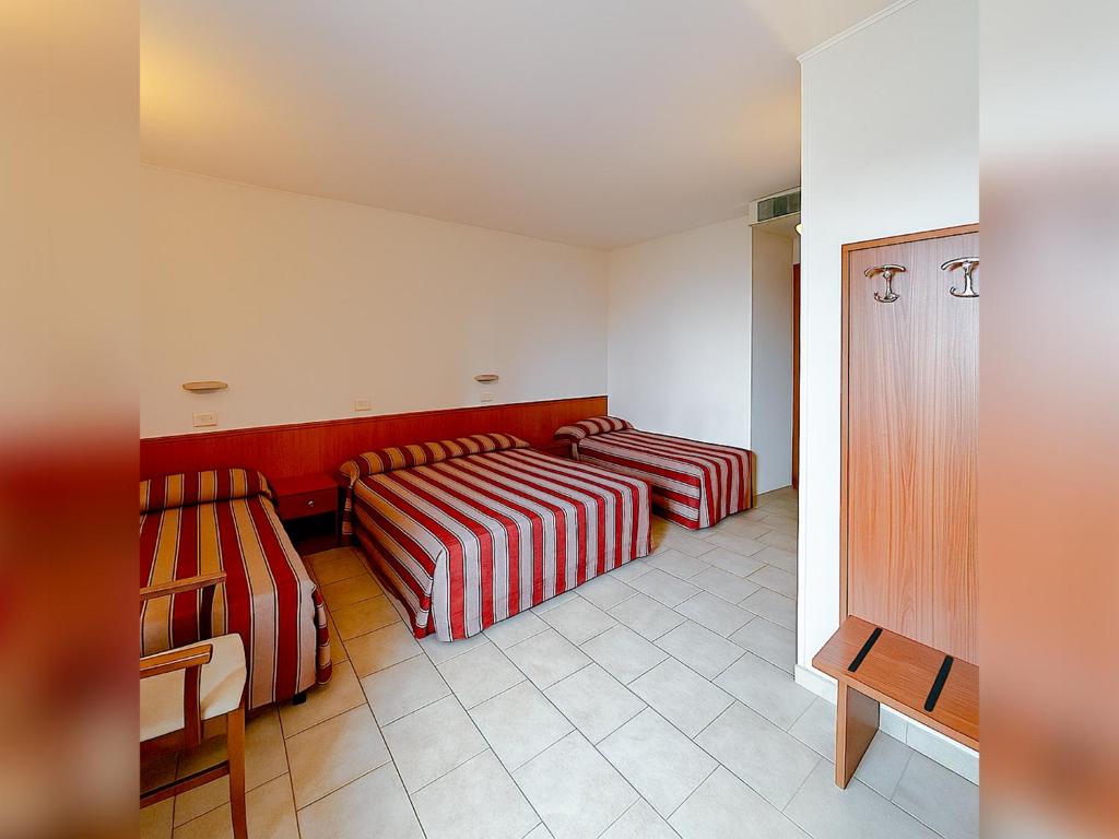 Postel nebo postele na pokoji v ubytování Hotel e Appartamenti La Solaria