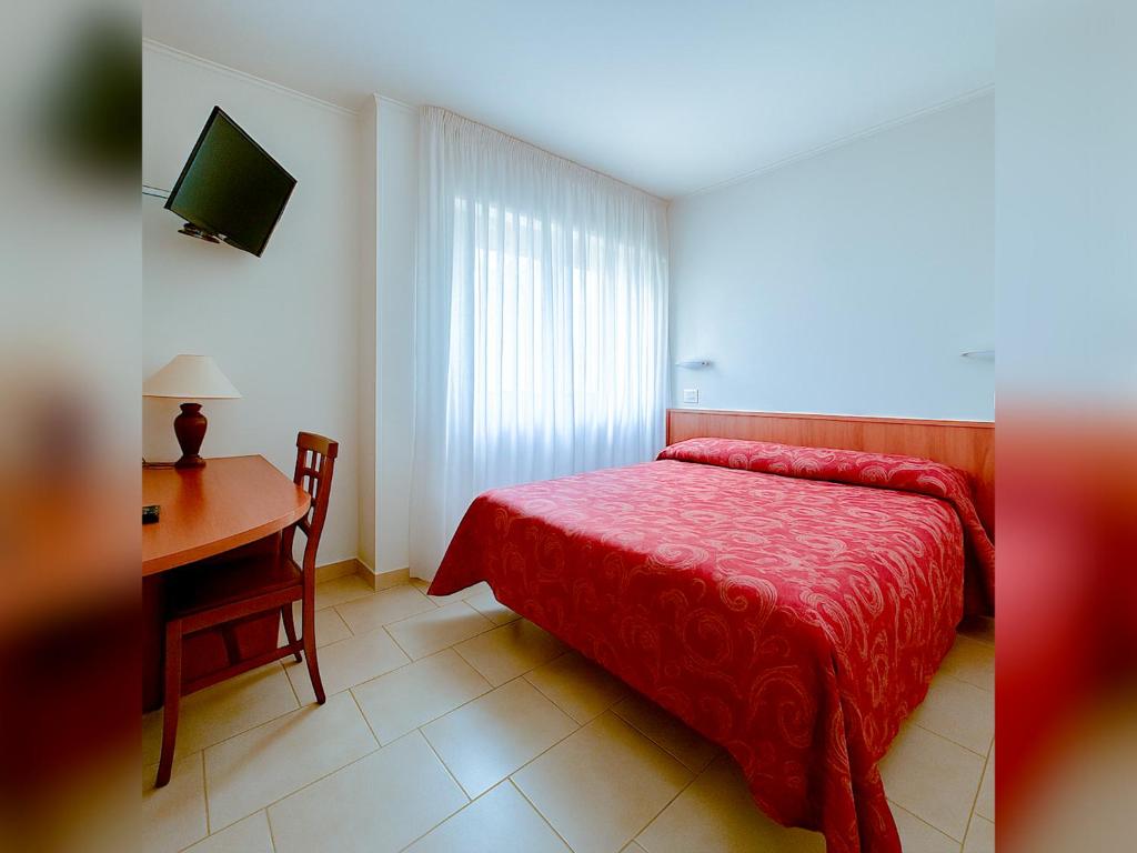 Postel nebo postele na pokoji v ubytování Hotel e Appartamenti La Solaria