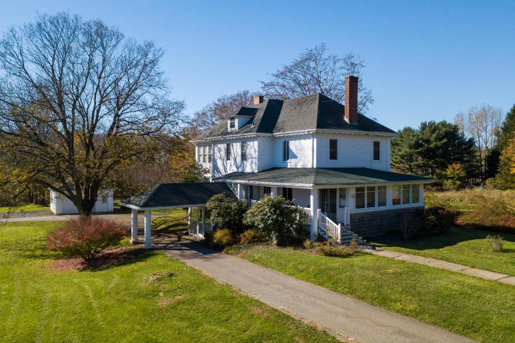 a large white house with a chimney on top at The Kinley House in Lunenburg