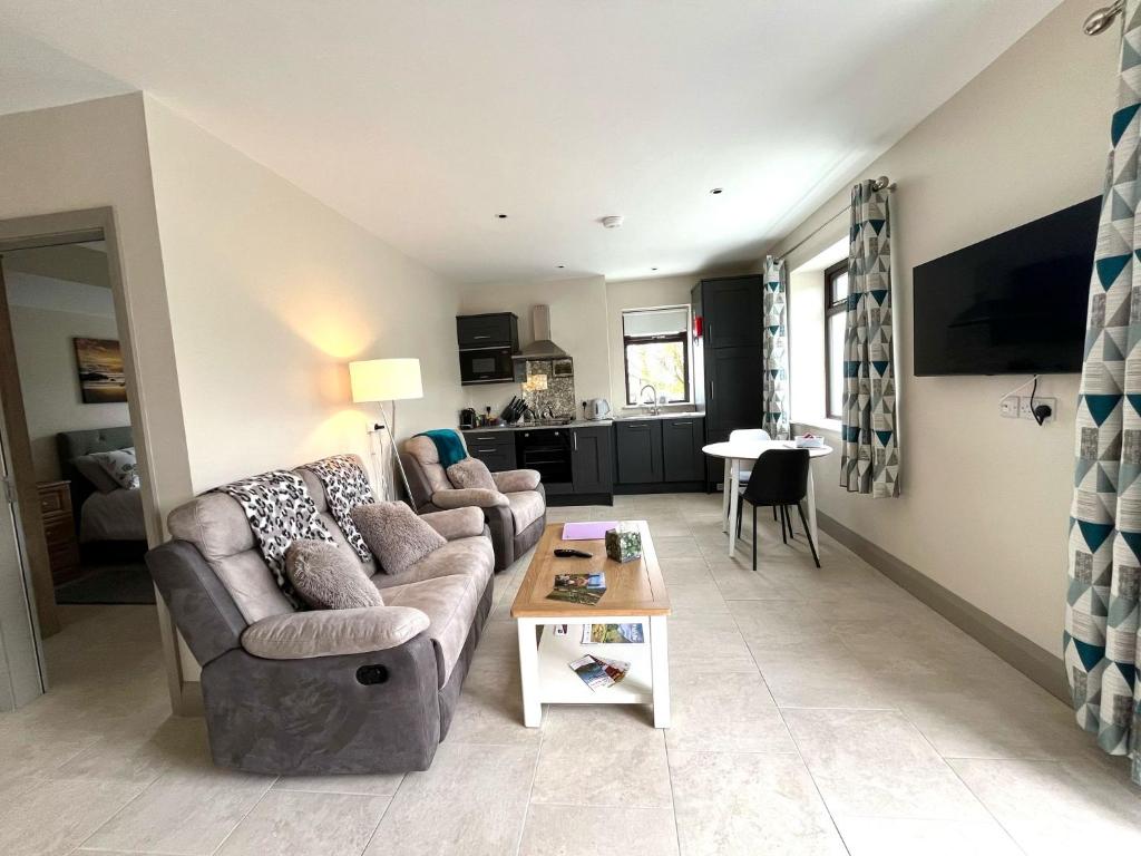 a living room with a couch and a table at Tigh Fitz Apartments - Inis Mór, Aran Island in Inis Mor