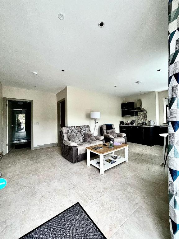a living room with a couch and a table at Tigh Fitz Apartments - Inis Mór, Aran Island in Inis Mor