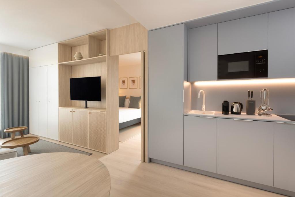 a hotel room with a kitchen and a bedroom at Staybridge Suites & Apartments Malaga by IHG in Málaga