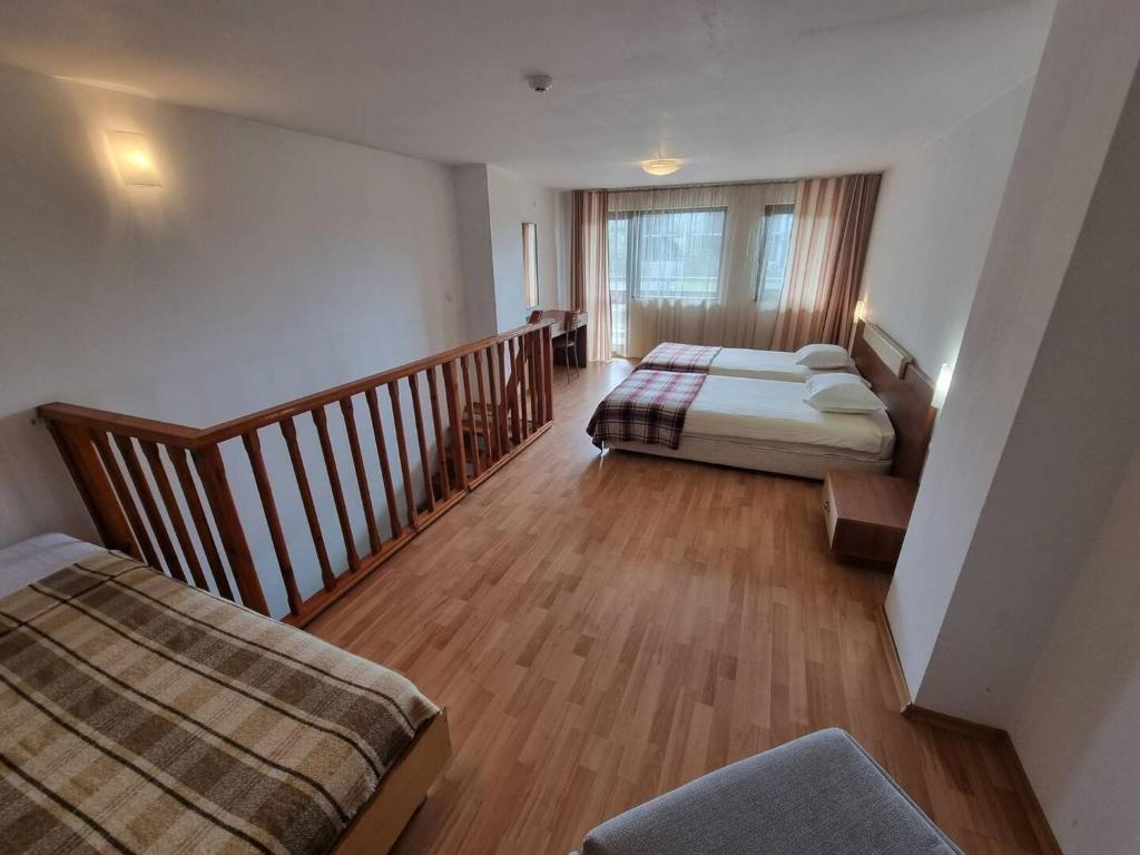 a large room with two beds and a staircase at Mountain Paradise 1 - 1 Bedroom Homey Two Floor Apartment - Washer in Bansko