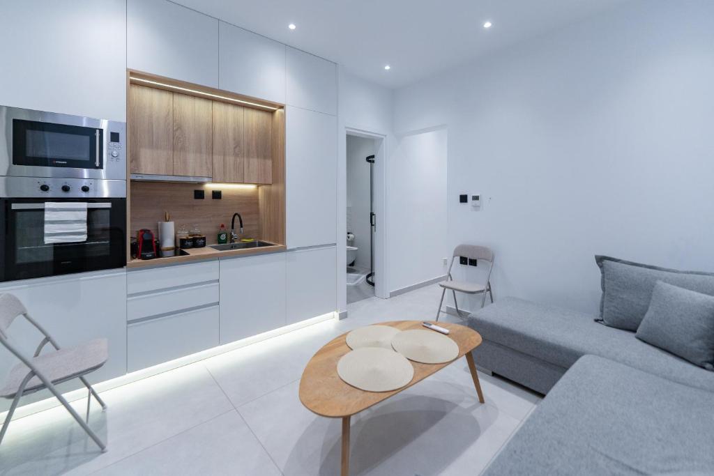 a living room with a couch and a table at MONOPATI Apartments in Mouzákion