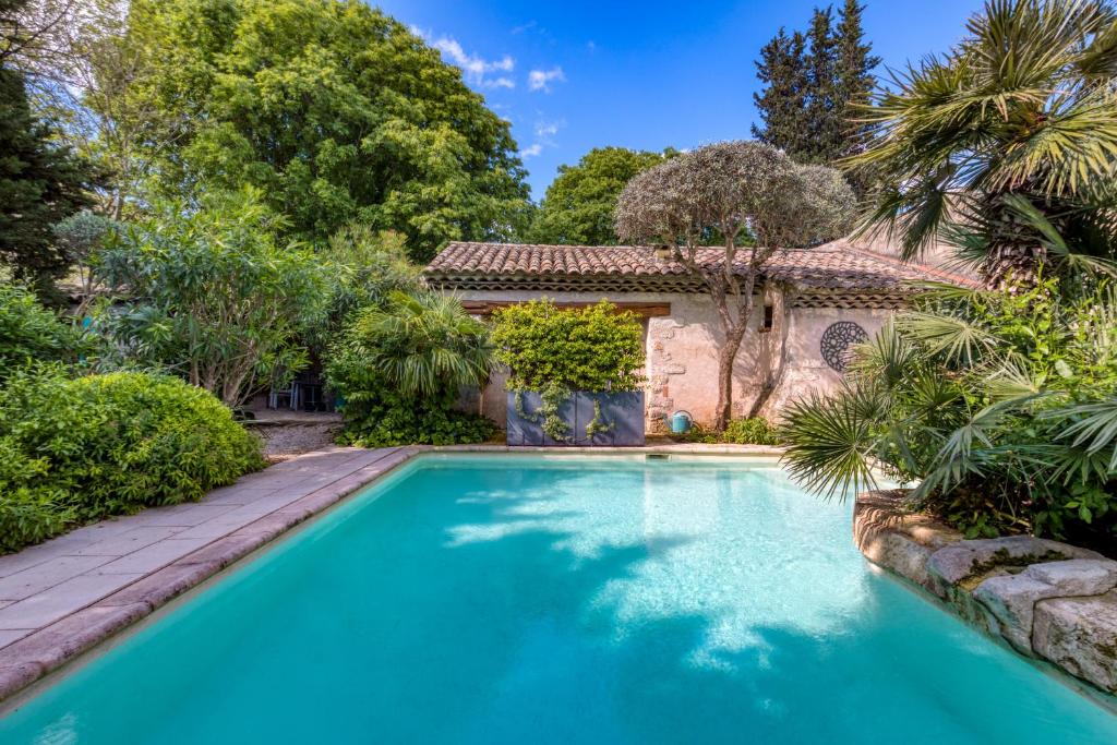 une piscine devant une maison avec des arbres dans l'établissement Villa - Oasis centre charme, à Montpellier