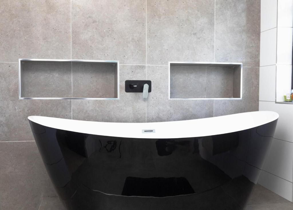 a bathroom with a large white bath tub at Bluewater Bay Escape in Gqeberha