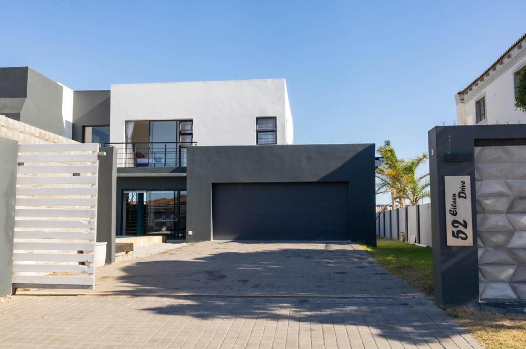 a garage in front of a house with a fence at Bluewater Bay Escape in Gqeberha