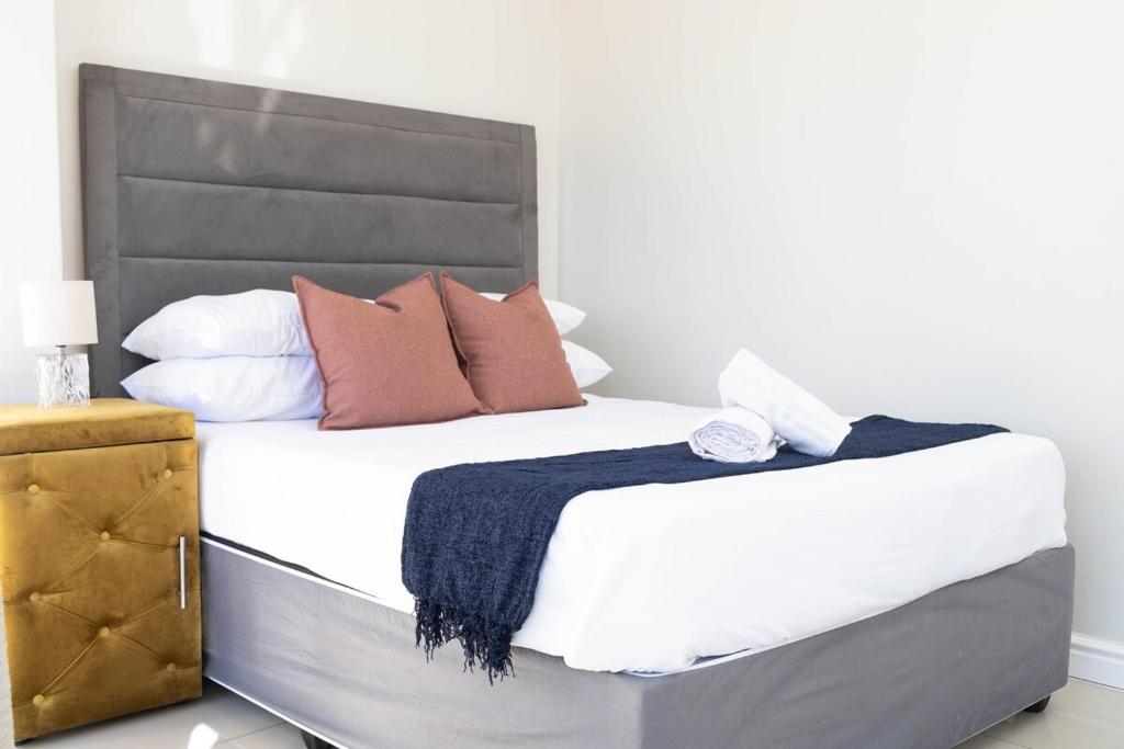 a bedroom with a large bed with white sheets and pillows at Bluewater Bay Escape in Gqeberha
