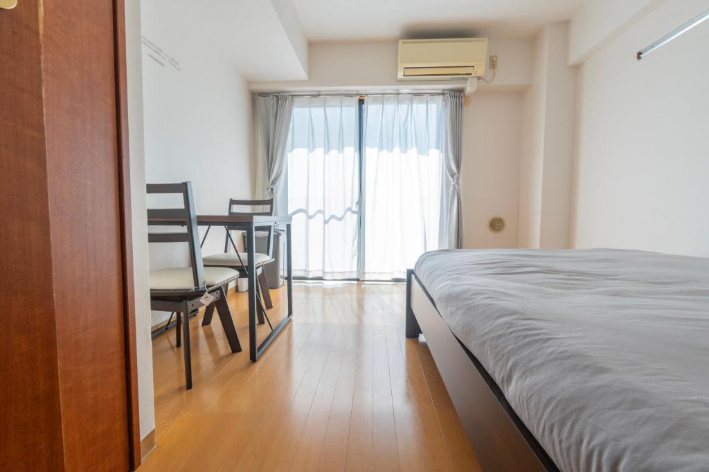una camera da letto con un letto, un tavolo e delle sedie di 森下駅徒歩2分 両国 東京スカイツリー直通の快適ステイ Dsx a Tokyo