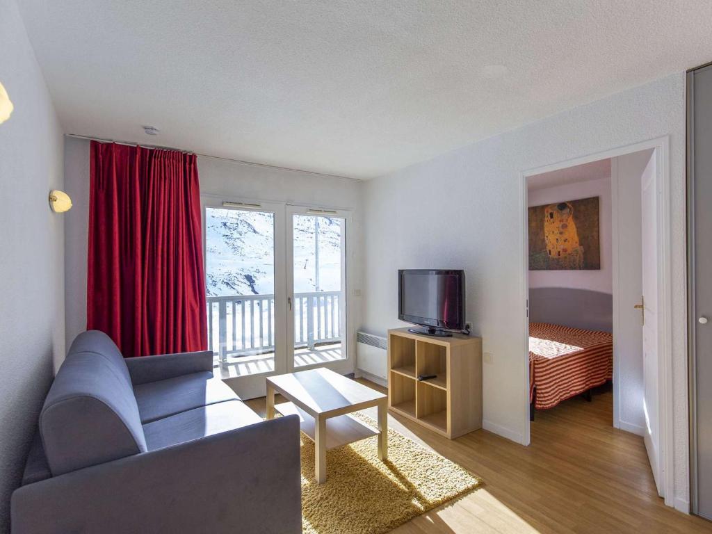 un salon avec un canapé et une télévision dans l'établissement Charmant T2 avec Terrasse, Parking, Piscine Couverte et Salle de Fitness - FR-1-404-312, à Bagnères-de-Bigorre