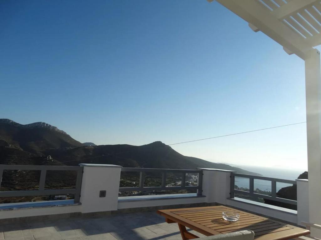 a balcony with a table and a view of the ocean at Skopelitis Village in Katapola