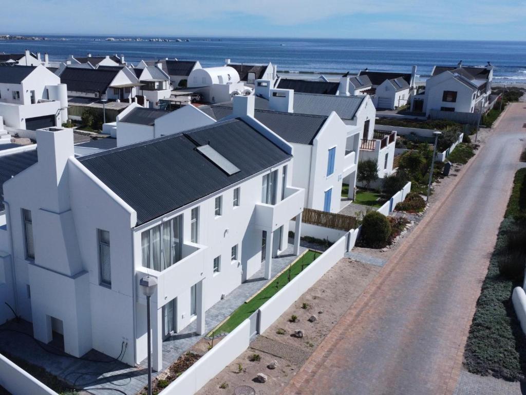 an aerial view of a row of white houses at Skye in Paternoster