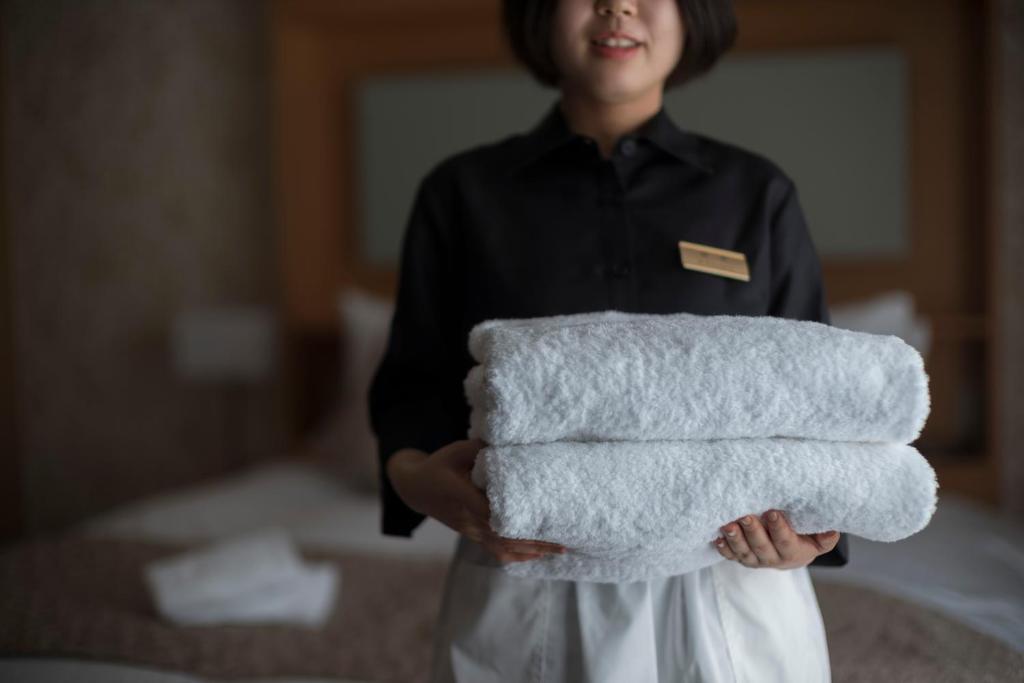 Postel nebo postele na pokoji v ubytování Kyoto Shinmachi Rokkaku Hotel grandereverie