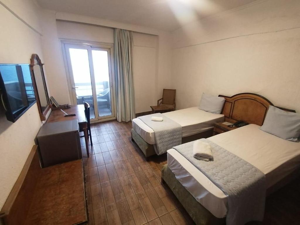 Postel nebo postele na pokoji v ubytování Kaoud Sporting Hotel