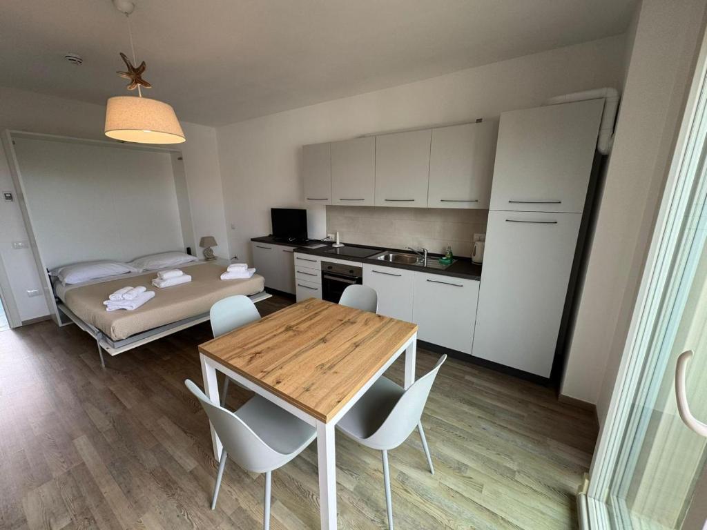 a kitchen and dining room with a table and chairs at Residence San Francesco in Tirrenia