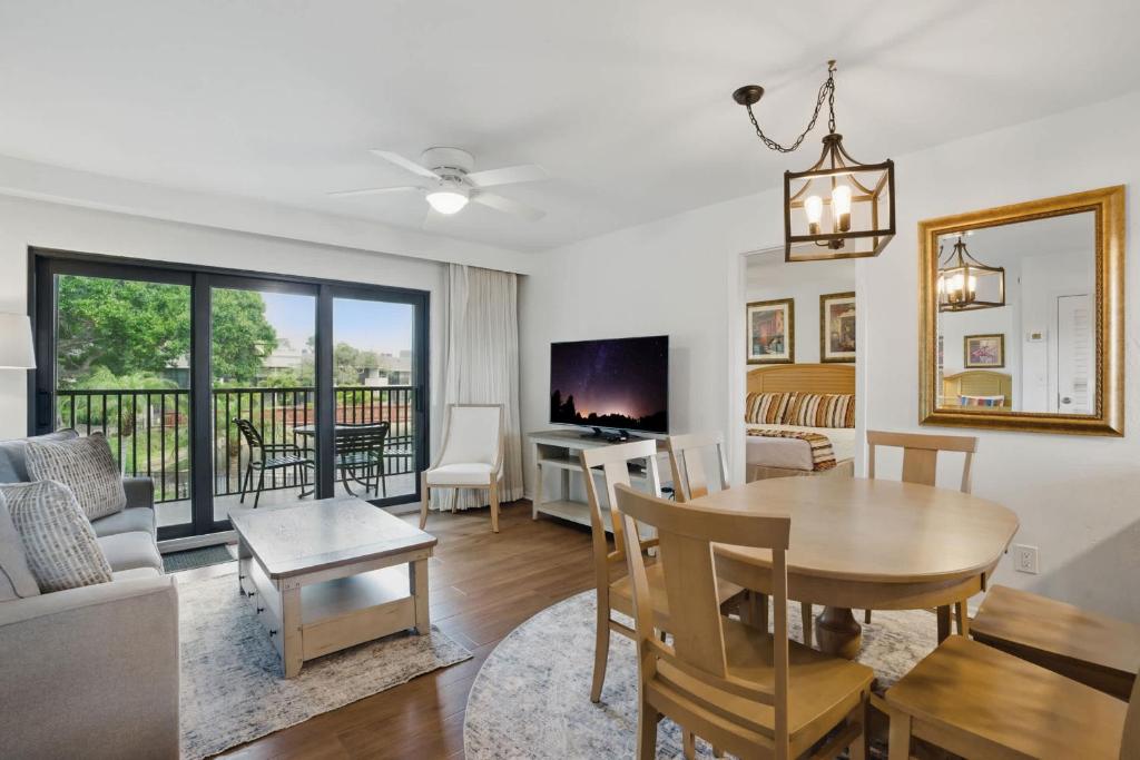 Una sala de estar con una mesa y un comedor. en Deluxe Condo with Lake Views, en Naples