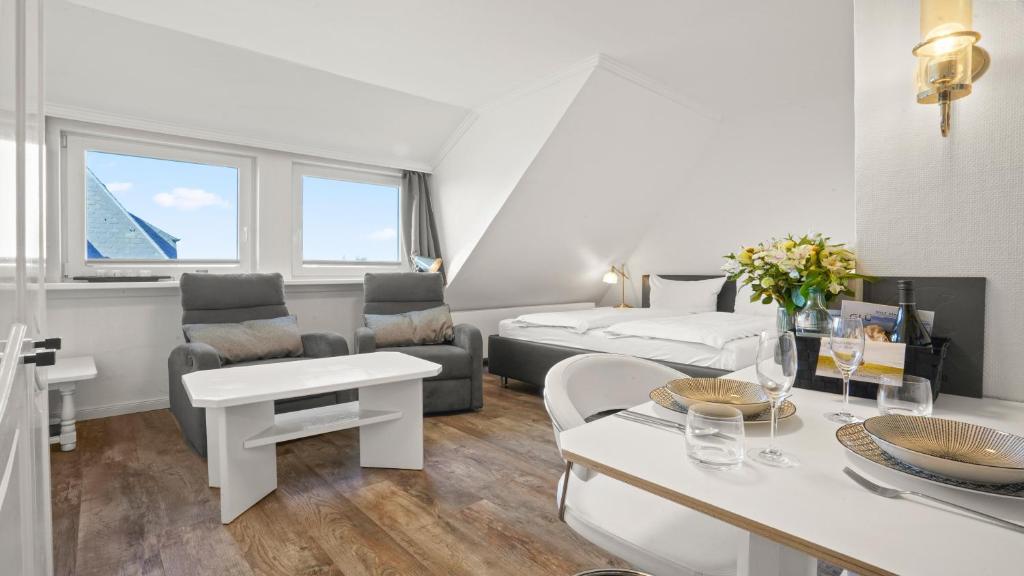 a living room with a bed and a couch at Gurtdeel Meer Blick-Suite in Hörnum