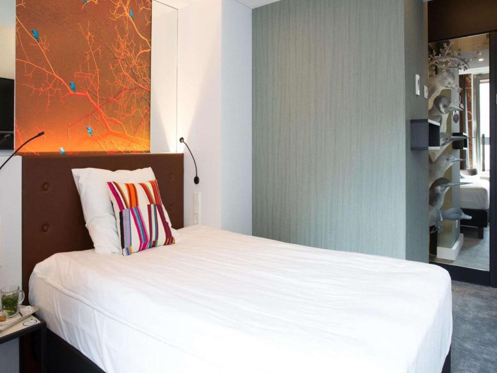 Postel nebo postele na pokoji v ubytování Golden Tulip Hotel Central