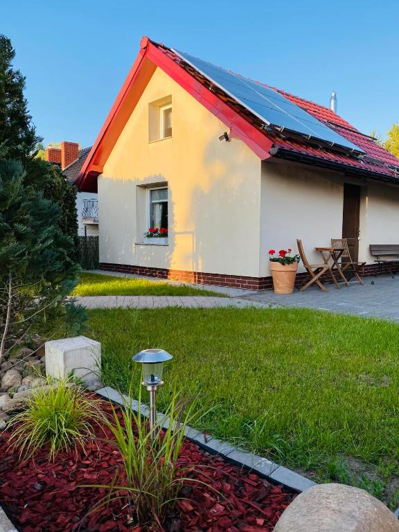 a yellow and white house with a red roof at Noclegi u Justyny in Łagów
