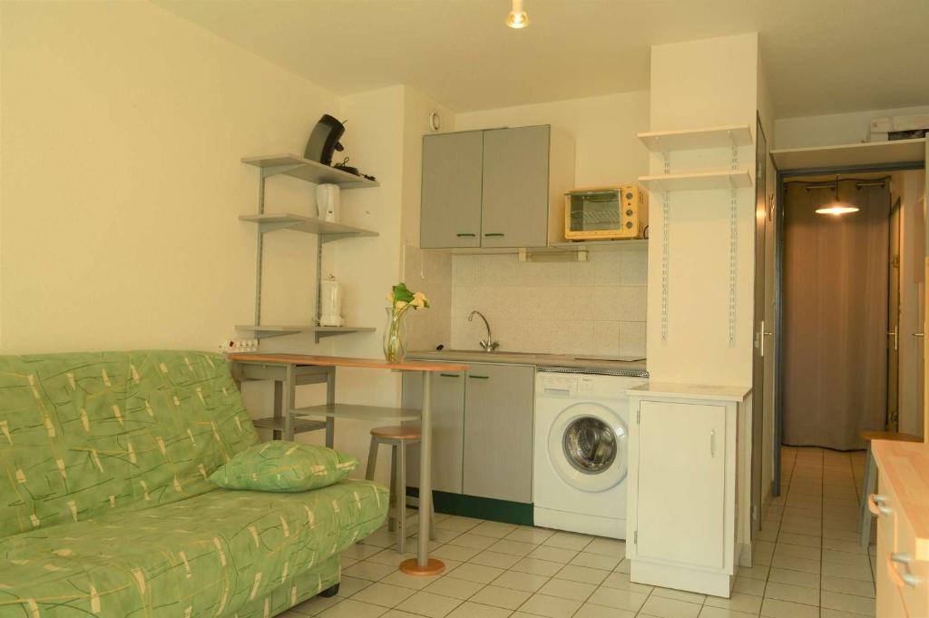 un salon avec un canapé et une cuisine dans l'établissement Studio cabine 4 couchages ARGELES SUR MER AR070-102, à Argelès-sur-Mer