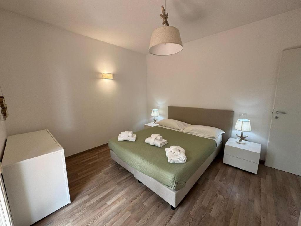 a bedroom with a bed with towels on it at Residence San Francesco in Tirrenia